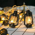 Vintage mini oil lantern string lights with warm golden bulbs and black fixtures